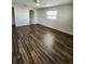 Bright bedroom with wood flooring, a ceiling fan, and a window at 345 Three Lakes Ln # L, Venice, FL 34285