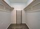 Organized closet with built-in shelving and rods for ample storage, with wood flooring at 345 Three Lakes Ln # L, Venice, FL 34285
