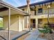 Inviting two-story condo with a carport, private balcony, and neatly kept landscaping for a comfortable and welcoming entryway at 345 Three Lakes Ln # L, Venice, FL 34285