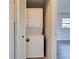 Convenient laundry closet with stacked washer and dryer located next to the doorway at 345 Three Lakes Ln # L, Venice, FL 34285