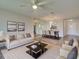 Staged living and dining room area with ample natural light and wood plank flooring at 345 Three Lakes Ln # L, Venice, FL 34285