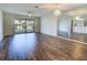 Living room featuring wood floors, mirrored wall and sliding glass doors to the outside at 345 Three Lakes Ln # L, Venice, FL 34285