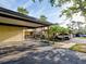 Covered parking spot with mature landscaping and sidewalks at 345 Three Lakes Ln # L, Venice, FL 34285