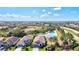 Stunning aerial view of home with tile roof situated on a lush lot with a pond view and mature landscaping at 351 Carlino Dr, Nokomis, FL 34275