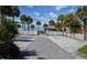 Beach access walkway lined with palm trees, offering a picturesque route to the sandy shore at 397 Flamingo Dr, Venice, FL 34285