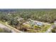 A stunning aerial view of a home nestled in a lush, green landscape with mature trees at 4054 Coalingo St, North Port, FL 34291