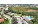 Aerial shot of the community recreation center with tennis courts, bocce ball and pool, surrounded by landscaping at 4210 Vicenza Dr # A25, Venice, FL 34293