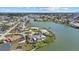 Stunning aerial view showcasing a waterfront property with lush landscaping in a desirable neighborhood at 424 Shade Ter, Venice, FL 34293