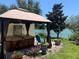 Outdoor hot tub features a gazebo, seating, and view of the lake at 424 Shade Ter, Venice, FL 34293