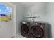 Bright laundry room features a modern washer and dryer set for convenient home chores at 424 Shade Ter, Venice, FL 34293