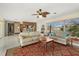 Bright living room with tile flooring, ceiling fan, and large windows at 424 Shade Ter, Venice, FL 34293
