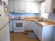 Traditional kitchen with white cabinetry, appliances, and light countertops offering a clean design at 425 Boxwood Dr, Venice, FL 34285