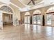 Spacious clubhouse with tile flooring, arched doorways, and access to outdoor amenities at 4340 Via Del Santi, Venice, FL 34293