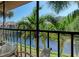 Screened balcony with seating area overlooking lush greenery and water at 630 Bird Bay E Dr # 208, Venice, FL 34285
