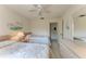 Comfortable bedroom with two twin beds, ceiling fan, and natural light from the large window at 630 Bird Bay E Dr # 208, Venice, FL 34285