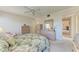 Cozy bedroom featuring tropical floral bedspread and dual dressers, lit by a ceiling fan at 630 Bird Bay E Dr # 208, Venice, FL 34285