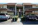 Charming condo exterior features assigned parking, well-maintained landscaping, and inviting stairways to upper units at 630 Bird Bay E Dr # 208, Venice, FL 34285