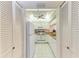 Functional galley kitchen with white appliances, ample cabinet space, and bright lighting at 630 Bird Bay E Dr # 208, Venice, FL 34285