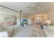 Bright living room featuring comfortable seating, a ceiling fan, and an open layout to the dining area at 630 Bird Bay E Dr # 208, Venice, FL 34285
