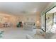 Cozy living room with comfortable seating, ceiling fan, access to the balcony, and a dining area at 630 Bird Bay E Dr # 208, Venice, FL 34285