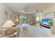Inviting living room featuring a ceiling fan, plush carpeting, a large window and access to the balcony at 630 Bird Bay E Dr # 208, Venice, FL 34285