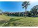 Scenic pond view with lush landscaping, creating a peaceful backdrop at 630 Bird Bay E Dr # 208, Venice, FL 34285