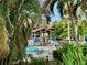 Secluded community pool area offering a peaceful retreat with lounge chairs, covered seating, and tropical landscaping at 630 Bird Bay E Dr # 208, Venice, FL 34285