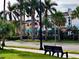 Scenic street view with palm trees lining the road and charming buildings in the backdrop at 630 Bird Bay E Dr # 208, Venice, FL 34285