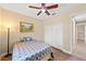 Comfortable bedroom featuring a ceiling fan, neutral walls, and stylish wood-look floors at 6331 Mckinley Ter, Englewood, FL 34224