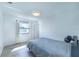 An airy bedroom features wood-look floors and a large window at 638 Bird Bay E Dr # 201, Venice, FL 34285