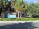 Venice Beach entrance sign with palm trees and lush greenery in Florida at 638 Bird Bay E Dr # 201, Venice, FL 34285