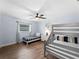 Bright bedroom featuring a bunk bed, twin bed, ceiling fan and window at 8 Bunker Ln, Rotonda West, FL 33947