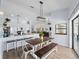 Bright and airy dining room open to the kitchen boasts modern light fixtures and an adjacent view of the living room at 8 Bunker Ln, Rotonda West, FL 33947