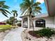 Close up of a welcoming front entrance with a curved walkway and arched doorway with a bright door at 8 Bunker Ln, Rotonda West, FL 33947