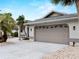 Attached two-car garage features impact windows and paved driveway at 8 Bunker Ln, Rotonda West, FL 33947