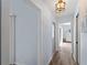 Bright hallway with modern lighting offering views into the rooms at 8 Bunker Ln, Rotonda West, FL 33947