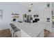 Eat-in kitchen featuring white cabinets, stainless appliances, bar seating, and modern countertops offer a stylish space at 8 Bunker Ln, Rotonda West, FL 33947