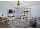 Comfortable living room featuring a large window, TV and modern furniture at 8 Bunker Ln, Rotonda West, FL 33947