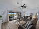 Inviting living room with sliding doors to the pool, ceiling fan, and seamless flow to the adjacent dining area at 8 Bunker Ln, Rotonda West, FL 33947