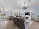 Expansive living room featuring vaulted ceilings, modern light fixtures, and wood-look floors creating a cozy atmosphere at 8 Bunker Ln, Rotonda West, FL 33947