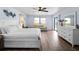 Main bedroom featuring a sitting area, dresser, ceiling fan, and sliding glass doors at 8 Bunker Ln, Rotonda West, FL 33947