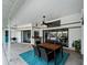 Inviting outdoor dining area with a ceiling fan, grill, and scenic views of the pool and lush backyard at 8 Bunker Ln, Rotonda West, FL 33947
