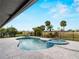 Beautiful pool and spa overlooking a large lawn with mature landscaping and a decorative fence line at 8 Bunker Ln, Rotonda West, FL 33947