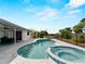 Backyard featuring a pool and spa offering a relaxing retreat with lush landscaping and serene views at 8 Bunker Ln, Rotonda West, FL 33947