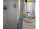 Bathroom featuring a glass-enclosed shower and vanity sink with storage beneath; natural light at 88 Bainbridge Dr # 88, Nokomis, FL 34275