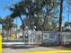 Gated entry of King's Gate Park Condominium, age 55+, with white fencing and a manicured landscape at 88 Bainbridge Dr # 88, Nokomis, FL 34275