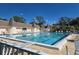 Large community pool with lounge chairs, offering a refreshing retreat with clear water and sunny skies at 88 Bainbridge Dr # 88, Nokomis, FL 34275