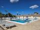 Spacious community pool area with plenty of seating, offering a serene and inviting space under clear blue skies at 88 Bainbridge Dr # 88, Nokomis, FL 34275