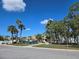Charming single-story home with mature palm trees in a sunny landscape and bright blue skies at 88 Bainbridge Dr # 88, Nokomis, FL 34275