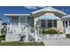 Welcoming single-Gathering home featuring a screened porch and a striped awning at 88 Bainbridge Dr # 88, Nokomis, FL 34275